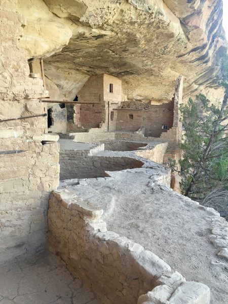 Masonry rooms built under an overhanging rock face