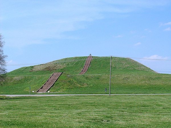 A very large flat-topped grass-covered earthen mound with a long staircase up its front