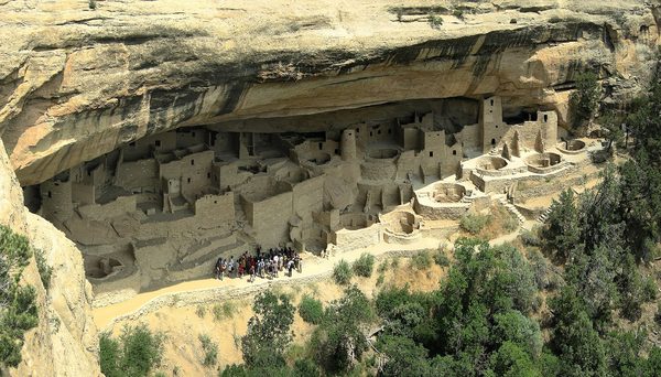 A large stone village built into a recess in a cliff face